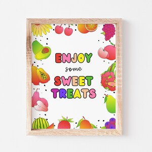 May include: A framed printable sign with a white background and a colorful border of fruit illustrations. The text on the sign reads "Enjoy some sweet treats".