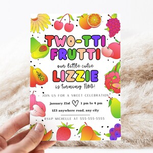 May include: A colorful invitation card with a fruit theme. The text reads "Two-tti Frutti our little cutie Lizzie is turning Two!" with a heart and the date "January 21st 1 pm to 4 pm". The address is "123 anywhere road, any city". The RSVP information is "RSVP Michelle at 555-555-5555".