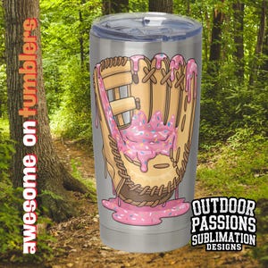 May include: A stainless steel tumbler with a pink and white donut-shaped baseball glove graphic. The graphic has sprinkles and pink icing dripping down the side of the glove. The tumbler is a sublimation design.