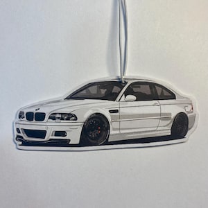 May include: White car air freshener with a black and white illustration of a BMW M3.