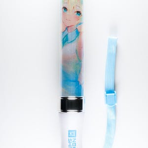 May include: A white light-up stick with a blue and white anime character image. The stick has a silver top and bottom and a blue strap. The text "NEON SHRINE" is printed on the stick.
