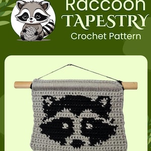 May include: Crochet pattern for a raccoon tapestry. The tapestry is gray with a black raccoon face in the center. The tapestry is hanging from a wooden dowel rod.