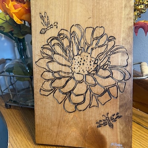 Wood burned flower with bees