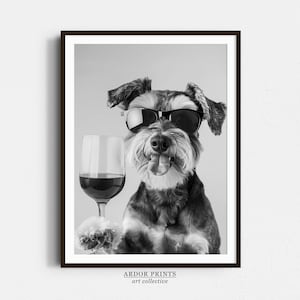 Puede incluir: Fotografía en blanco y negro de un perro con gafas de sol y sosteniendo una copa de vino. El perro mira directamente a la cámara con una expresión juguetona. La imagen está titulada "ARDOR PRINTS art collective".