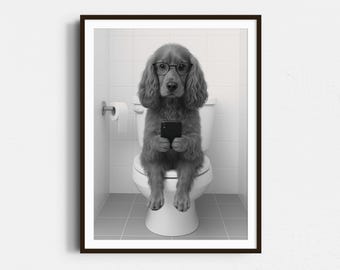 May include: A black and white photo of a dog wearing glasses and sitting on a toilet, holding a smartphone.