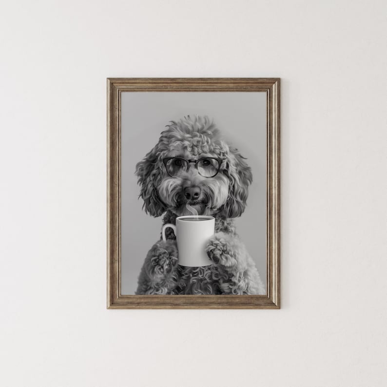 May include: A black and white photo of a dog wearing glasses and holding a white coffee mug. The dog is a poodle with a fluffy coat.