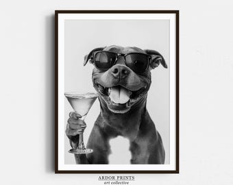 May include: A black and white photo of a dog wearing sunglasses and holding a martini glass. The dog is smiling and looking at the camera. The background is a white wall.