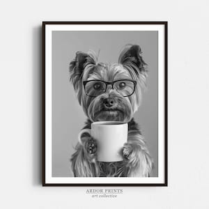 May include: A black and white photograph of a Yorkshire Terrier wearing glasses and holding a white coffee mug. The dog is looking directly at the camera.