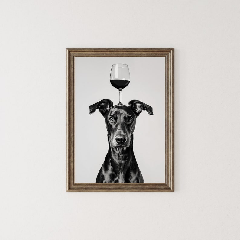 May include: Black and white photo of a dog with a glass of red wine balanced on its head.