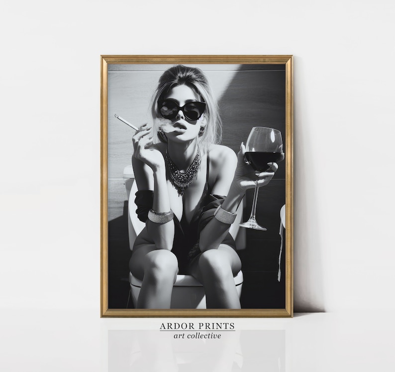 K&ouml;nnte beinhalten: Schwarzwei&szlig;foto einer Frau mit Sonnenbrille und schwarzem Oberteil, die auf einer Toilette sitzt und ein Glas Rotwein und eine Zigarette h&auml;lt.