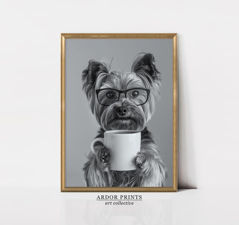 May include: A black and white photograph of a Yorkshire Terrier wearing glasses and holding a white coffee mug. The dog is looking directly at the camera.
