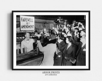 May include: Black and white photograph of a group of people celebrating in a bar. A sign above the bar reads "Farewell 18th Amendment".