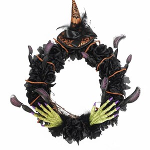May include: A Halloween wreath featuring black roses, witch hands with green skin and purple nails, and a witch hat with a black bow and feathers. The wreath has a circular shape and is decorated with dark accents.