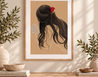 May include: A framed digital art print featuring a person with long, dark, wavy hair seen from behind, adorned with a single red rose. The figure is outlined in white against a solid tan background, holding an open book in their hands.