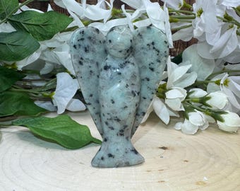 May include: A green and black speckled stone angel figurine. The angel has wings and a halo.