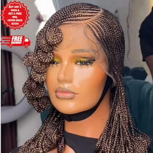 May include: A braided wig with a lace front. The wig features a combination of dark and light brown braids, with a side section styled into spiral curls. The model is wearing a black face mask.