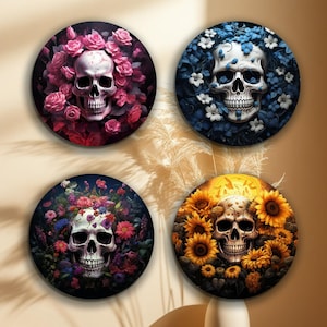 May include: Four round coasters with a skull surrounded by flowers. The coasters feature a pink, blue, purple, and yellow floral design.