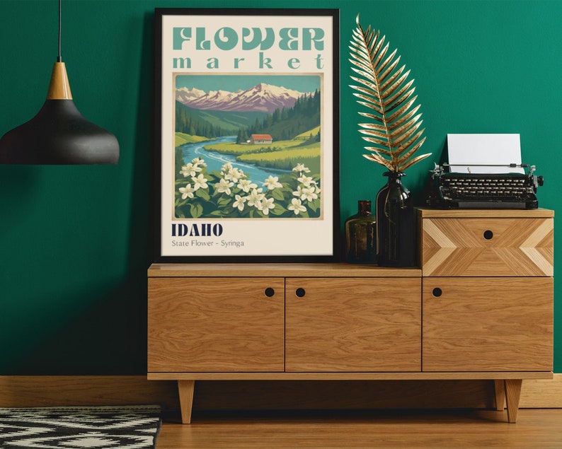 Może przedstawiać: Plakat w stylu vintage z tekstem "FLOWER market IDAHO State Flower - Syringa" i przedstawieniem rzeki płynącej przez dolinę z g&oacute;rami w tle.