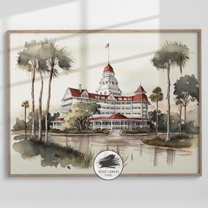 Op de afbeelding: Waterverfprint van een groot wit hotel met rode daken en een centrale toren, gelegen in een serene omgeving met palmbomen en een reflecterend water. Een Amerikaanse vlag wappert op de toren. Het kunstwerk is ingelijst.