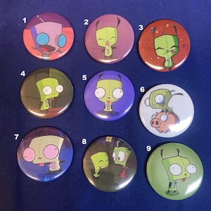 May include: Nine round buttons featuring a green alien character from the animated television series Invader Zim. The buttons are numbered 1 through 9 and feature different scenes from the show.