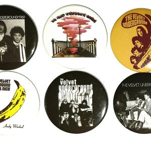 May include: Six circular badges featuring The Velvet Underground. The badges display band photos, album art, and the band's name. One badge has a yellow banana graphic.