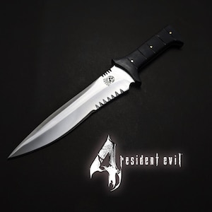 May include: A silver and black dagger with a serrated edge and a black handle with gold rivets. The dagger is displayed on a black surface, with the "Resident Evil 4" logo in the lower right corner.