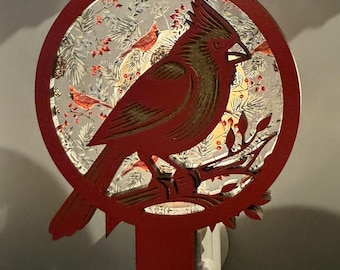 Cardinal Night light with a winter back drop