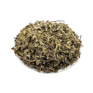 Peut inclure: Un tas d'herbes séchées vertes et brunes sur une surface blanche.