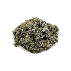 May include: A pile of dried, green, leafy herbs on a white plate.