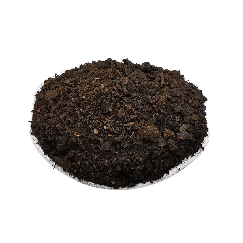 May include: A close-up of a pile of dark brown soil, likely for gardening or planting.