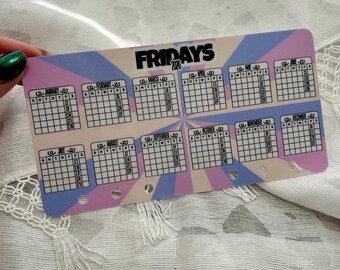 May include: A calendar card for the year 2020, featuring a design with a blue, pink, and beige color scheme. The word "FRIDAYS" is prominently displayed at the top, with monthly calendars arranged below. The card is held by a hand with a green nail polish.