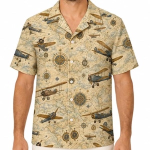 May include: A short-sleeve button-down shirt in a beige and tan color palette featuring an all-over print of vintage biplanes, compass roses, and navigational map lines. The shirt has a notched collar and a front button closure.