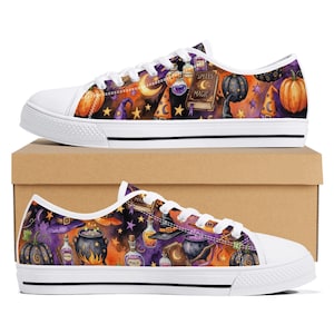 May include: Low-top canvas sneakers featuring a vibrant Halloween-themed print with orange pumpkins, purple witch hats, potion bottles, and a book labeled Spells Magic. The shoes have white laces, white rubber toe caps, and white soles with black trim.
