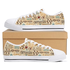 May include: White canvas sneakers with a coffee-themed pattern. The design includes coffee beans, cups, and text like "espresso," "latte," and "cappuccino." The shoes have white laces and soles, perfect for casual wear.