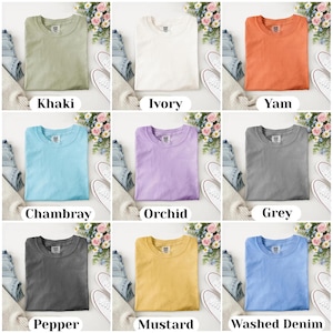 May include: Nine different colored t-shirts are displayed, each folded neatly. Colors include khaki, ivory, yam, chambray, orchid, grey, pepper, mustard, and washed denim. Each shirt is paired with jeans, a sweater, and white sneakers. The names of the colors are printed below each shirt.