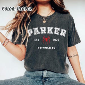 May include: A set of three ceramic mugs with a speckled, matte finish. The mugs are in shades of cream, light brown, and dark brown. Each mug has a simple, minimalist design, perfect for coffee or tea.