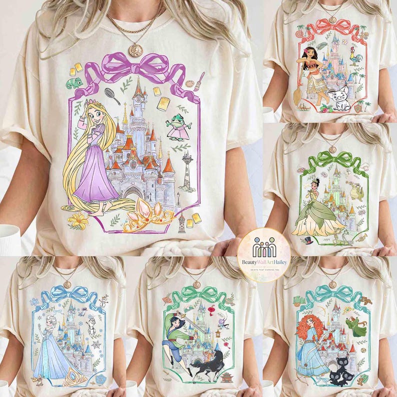 May include: Cream-colored t-shirts featuring various princess-themed designs. Each shirt showcases a different princess with a castle illustration, framed by a decorative border. The designs include Rapunzel, Moana, Tiana, Elsa, Mulan, and Merida.