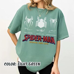 May include: A set of three ceramic mugs with a speckled, matte finish. The mugs are in shades of cream, light gray, and dark gray. Each mug has a simple, minimalist design and a rounded handle.