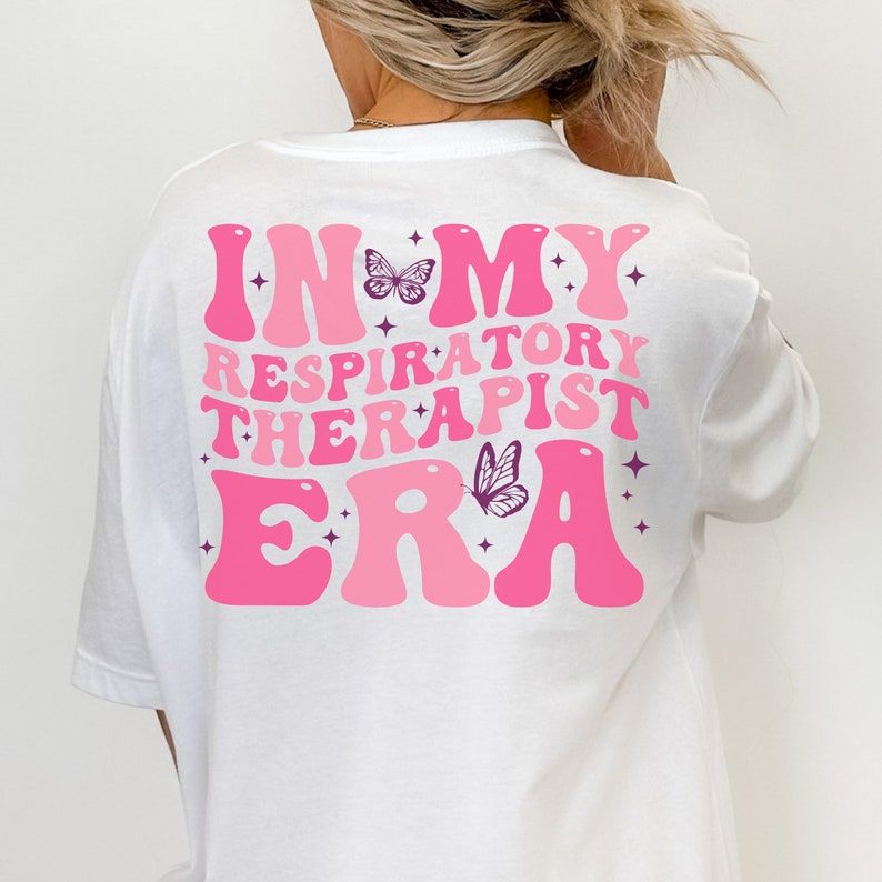 May include: White t-shirt with pink text that reads "In My Respiratory Therapist Era" with butterfly graphics.