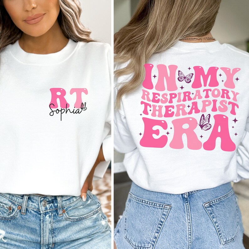 May include: White sweatshirt with pink lettering that says "In My Respiratory Therapist Era" with a butterfly graphic. The front of the sweatshirt has pink lettering that says "RT Sophia" with a butterfly graphic.