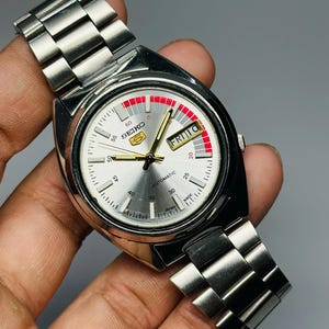 Reloj de pulsera Seiko 5 Automático Racer de segunda mano, esfera plateada, caja plateada, día/fecha, calibre n.º 7019A, fabricado en Japón.