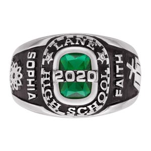 May include: A silver-toned class ring with a large, emerald-green gemstone at the center. The ring features the text "LANE HIGH SCHOOL 2020" and "SOPHIA FAITH" in black lettering. A decorative emblem is on the side.