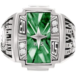 May include: A silver class ring with a rectangular green stone centre, a star, and the letters "HS". The ring has the numbers "20" and "15" on either side of the stone, with small clear stones on the sides.