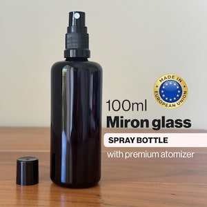 May include: A black Miron glass spray bottle with a premium atomizer and a capacity of 100ml. The bottle has a matching black cap and is labeled with the text "SPRAY BOTTLE". The product is marked as "MADE IN EUROPEAN UNION".