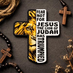 May include: Embroidered cross patch featuring a lion's face on the left side and text that reads "FEAR NOT FOR JESUS THE LION OF JUDAH HAS TRIUMPHED." The patch is yellow, black, and white. Religious themed.