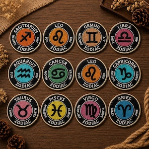 May include: A collection of twelve round embroidered patches, each featuring a different zodiac sign symbol and the word "ZODIAC". The patches are in various colors, including orange, blue, green, and pink, with black borders.