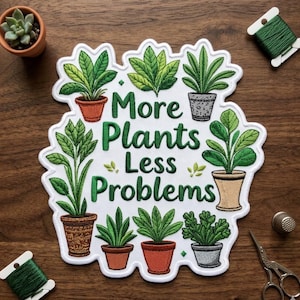 May include: Embroidered patch with the phrase "More Plants Less Problems" surrounded by various potted plants in shades of green and brown. The patch is white with a scalloped edge. A small succulent in a terracotta pot is visible.