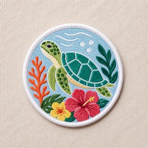 May include: Embroidered patch featuring a green sea turtle swimming in blue water with bubbles and white wave lines. The patch includes orange coral, green leaves, and red and yellow flowers, all within a white-bordered circle.