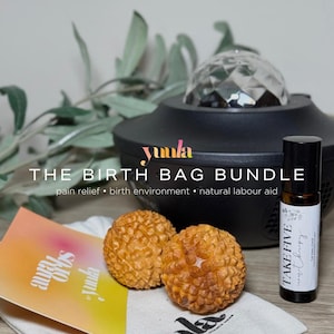 May include: A birth bag bundle containing a black light projector, two wooden massage balls, a small bag, and a bottle of essential oil. The bag is labelled "yuula" and the bottle is labelled "TAKE FIVE - calming"