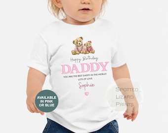 May include: A white short-sleeved t-shirt featuring a graphic of two teddy bears, the text Happy Birthday DADDY, YOU ARE THE BEST DADDY IN THE WORLD! LOTS OF LOVE, and the name Sophie in pink script, finished with a small pink heart icon.